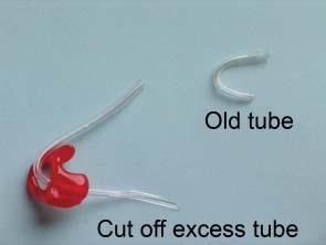 alongside the newly threaded mould. Measure and cut as shown. 1. Detach earmould and remove old tube.