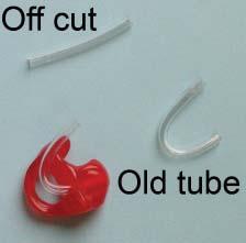Pull the point of the tubing which emerges at the tip until the bend in the tube coincides with the