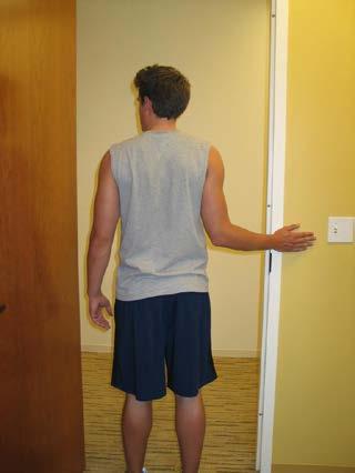FOUR CORNERS STRETCH 3. External Rotation Stand in a doorway with your hand on the wall as shown.