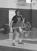 Having finished the pull, the lifter then jumps under the bar to catch it overhead in a deep squat position.