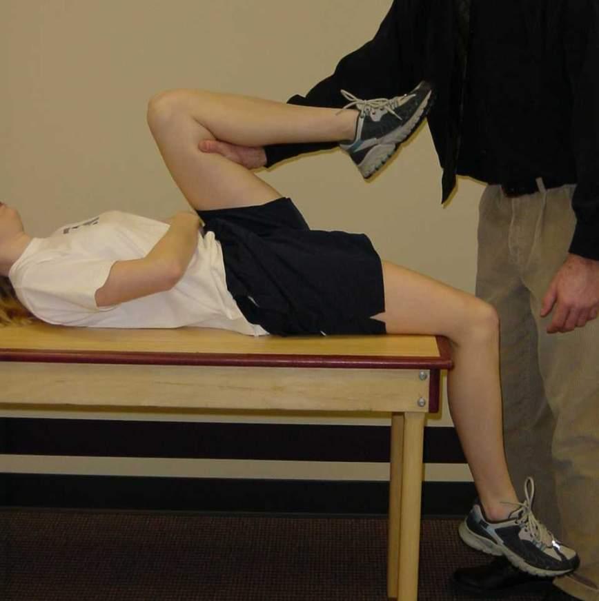 Passively stabilize the patient s hip from falling backward. Slowly allow the patient to lower their leg to the table. Repeat test on the opposite side.