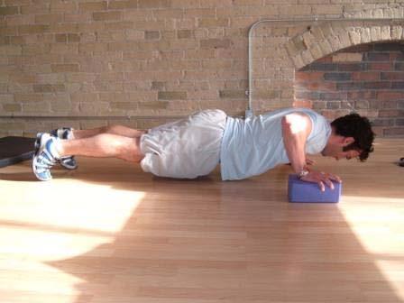 Hands are slightly wider than shoulder width apart (normal pushup width).