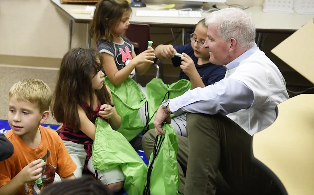 First-graders discover the contents of their Smiles at School backpacks.