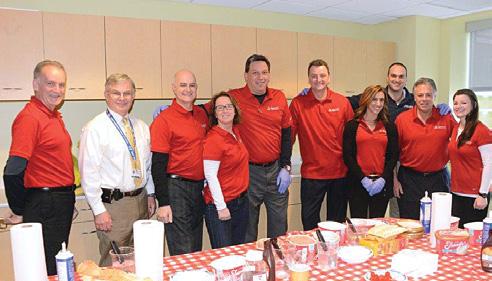 Employee volunteers scooped and topped sundaes with syrup and sprinkles for ice cream lovers of all ages.