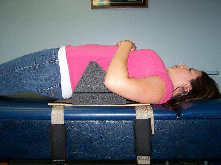 If it is below this level, add the one and/or two inch spacer blocks. Step Two: The patient relaxes backward over the fulcrum in a supine position.