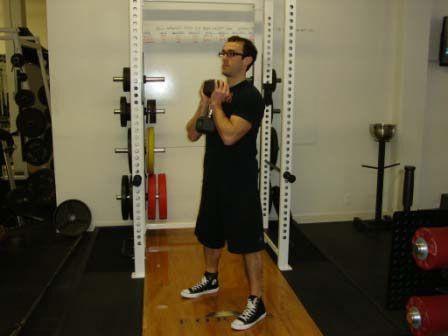 Workout A " Goblet Squat Stand with your feet just greater than shoulder-width apart.