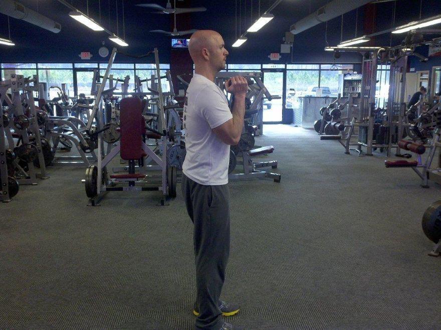 Workout B " Goblet Lunge Stand with your feet shoulder-width apart. Hold a dumbbell at chest height.