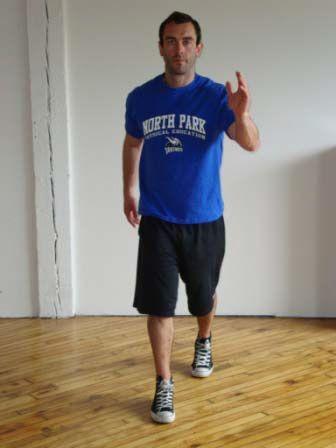 Split Shuffle Stand with one foot forward and the other back in a split stance. Raise your opposite arm and bring it forward.
