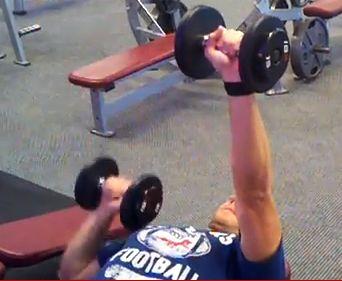 Lower one dumbbell to chest level while keeping the other dumbbell pressed up.