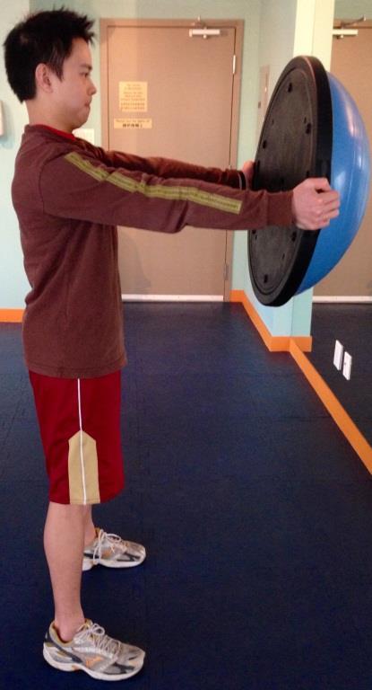 Once there, push BOSU forwards with arms extended. Bring BOSU back towards you and lift above head.