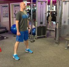 Workout A Bodyweight Squat Stand with your feet just greater than shoulder-width apart.