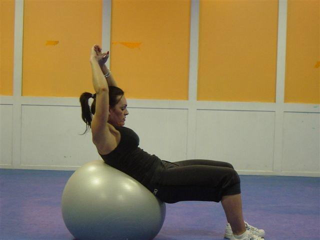 Keeping your hips up, use your abs to curl up. Hold at the top of the movement and return to the start position.