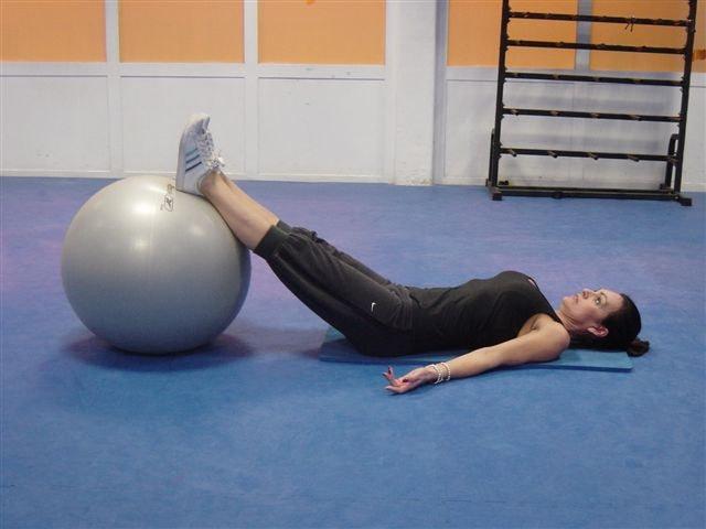 17 Supine Hip Extension The core muscles Glutes Lie on your mat, with your arms by your sides on the floor and palms facing up. Place your feet on the stability ball. This is the starting position.