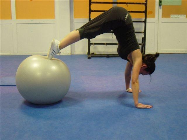 21 Pike position Lower abs Total Body! With your feet on the stability ball place your hands shoulder width in the floor.