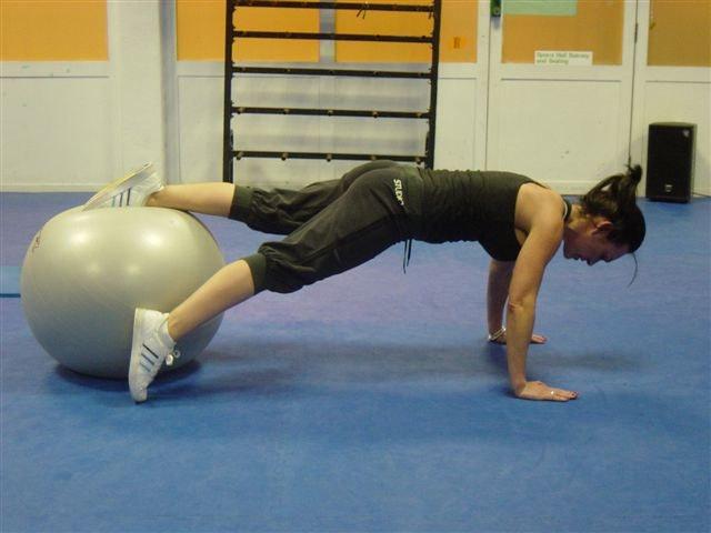 22 Leg Drop Abs Total Body With your feet on the stability ball place your hands shoulder width in the floor.