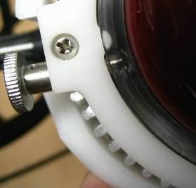 Thread the retaining screw clockwise into one of the grooves to secure the pump in place.