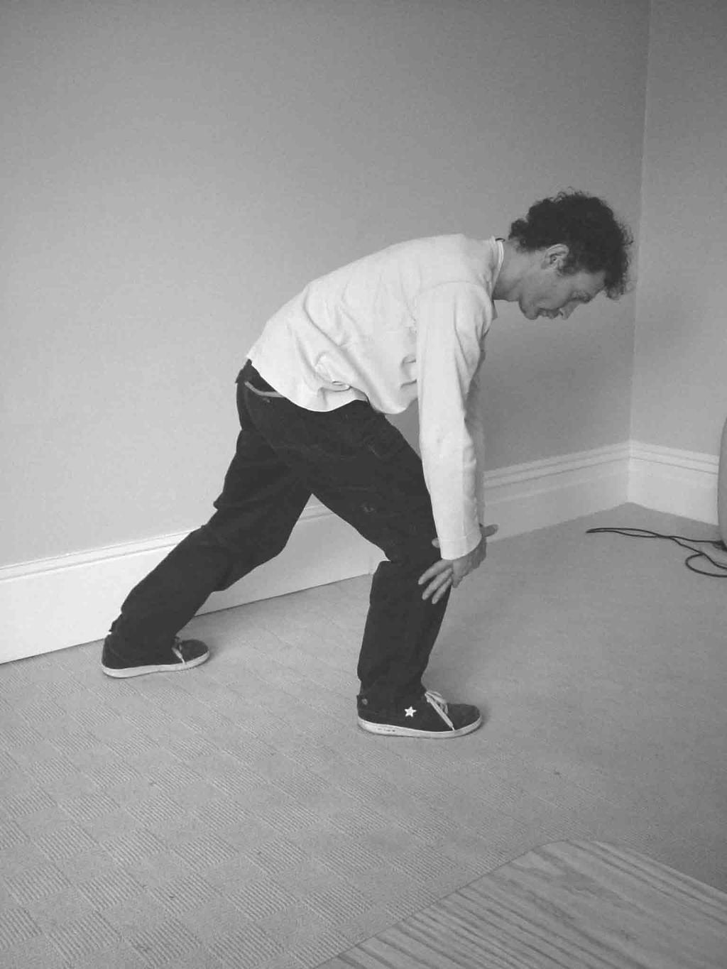 2. Shift your weight towards the front (right) leg. As you do so, lean forwards and downwards, relaxing your arms down in front of you until they cross over just below your (right) knee.