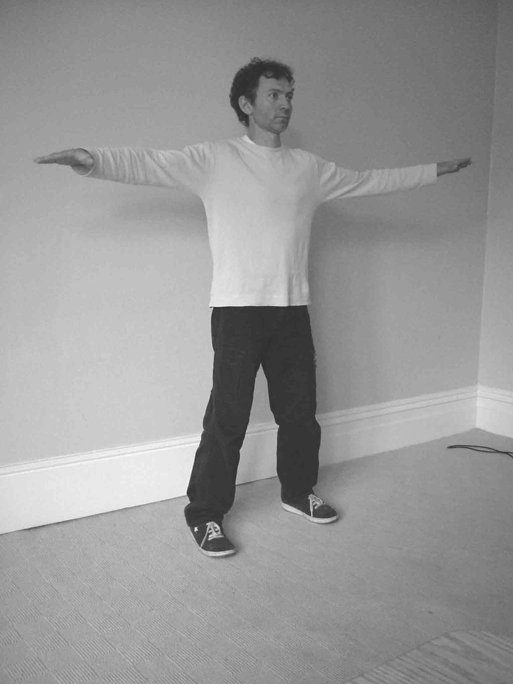 Stand naturally with the feet shoulder width apart, arms relaxed by your side.