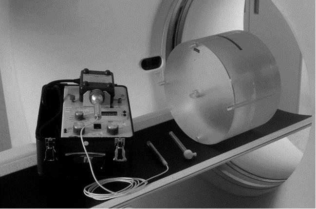 Figure 6: CTDI phantom, pencil ionization chamber, and electrometer 3. Dosimetry Scanning Instructions 1. Position the phantom appropriately at the isocenter of the scanner.