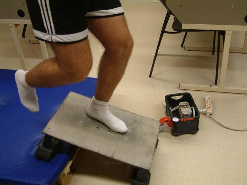 is hip extension over the platform to accomplish an eccentric action of the quadriceps (see Figure 10). Figure 10. Eccentric exercise for the quadriceps on the vibration platform.