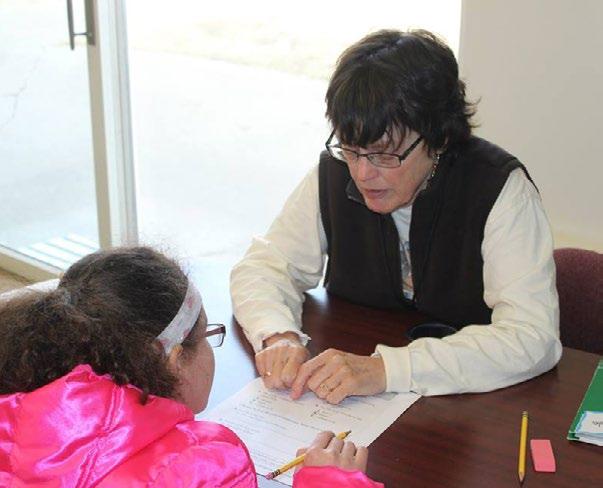 Tutor helping a child at Grace Place Shelter, photo courtesy of The Salvation Army
