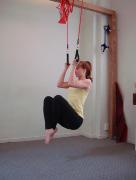 Exhale: Depress scapula, then flex elbows and adduct humerus to perform a modified pull up,