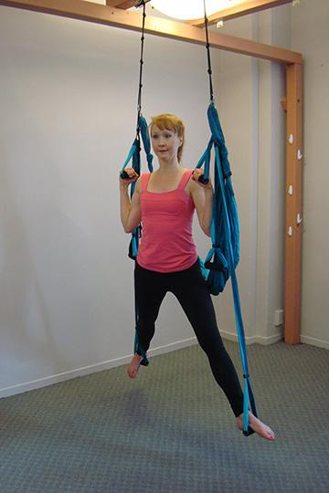 right leg in flexion, left leg in extension and lateral rotation Exhale, press into the straps with the feet and pull down on