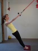 Support with the arms and bring the other foot to meet the front foot; extend elbows to create a one line between shoulders and ropes. Pelvis and spine are neutral, chin nodded.