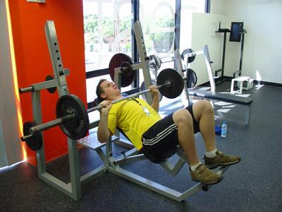 Setup: Lay down on the bench and set your feet firmly on the floor. Use a spotter to pass you the bar. Grip the bar using the correct grip. For how to find your correct grip, see the top tip below.