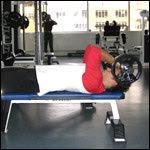 Reverse grip skull crushers Pick the loaded bar up off the ground and sit yourself down on a flat bench. With the bar resting on your thighs, lie back on the bench and bring the bar to your chest.