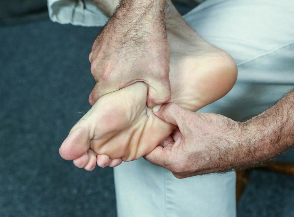 While maintaining this deep thumb pressure; dorsi flex and plantar flex the foot multiple times at each level. This stretches the long and short plantar ligaments. Note: This may be painful.