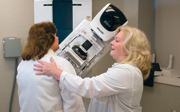 Marie Savarese, RT(R) (M), mammography technologist, performs a 3-D mammogram on a patient.