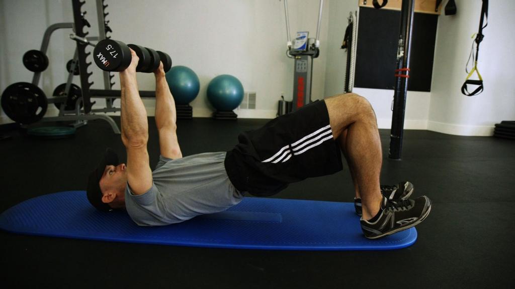 Alternating Arm Chest Press in Glute Bridge Elevate your hips into a glute bridge, keeping the pelvis stable and level. Push through your heels to better engage the glutes.