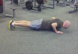 Triple Stop Pushup Keep abs braced and body in a straight line from knees to