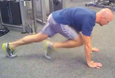 Keep your abs braced, pick one foot up off the floor, and slowly bring your knee up to