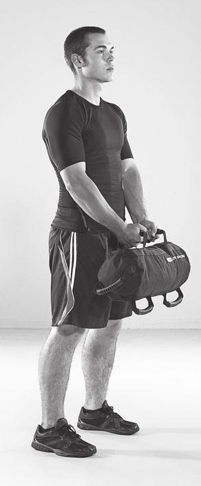 //// SUPER SANDBAG: LOWER BODY & CORE WORKOUT FORWARD LUNGE WITH ROTATION STEP 1 Stand with your feet shoulder width apart.