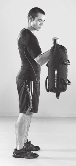 Hold the Super Sandbag with an underhand grip (palms facing out) in one hand.
