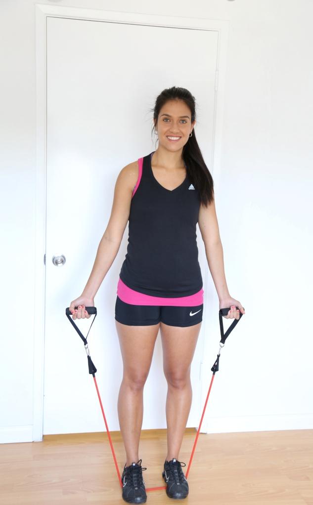 5. Standing Biceps Curl 1) Place your feet hip width apart on midpoint of the band.