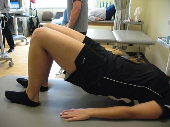 Elbow Press While lying face down, legs straight and feet slightly apart.