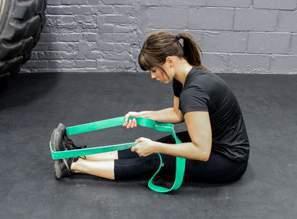 Wrap the band around the inside of your calf and back around your knee and grasp the other end of the band.