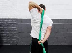 LOWERBACK/HAMSTRING: Loop the band around your feet, grasp onto the band and lean forward slightly while pulling the band toward you.