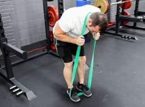 LAT PULL DOWN: Loop one end of the band around a pull up bar or use a door anchor to secure the band in the position needed to complete this exercise.