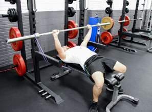CHEST EXERCISES RESISTANCE BENCH PRESS BENCH PRESS: Position yourself on a flat bench and loop bands on each side of the barbell.