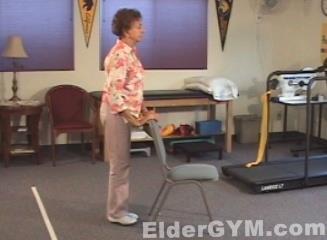 Hip Extension Stand, using a chair to balance yourself. Extend your leg backward, keeping your knee straight.