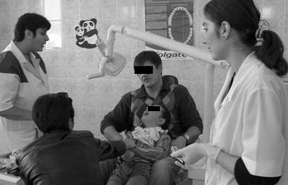 Figure 13. Case 2. The girl soon after wheelchair transfer, extremely negative behavior (Frankl 1), dental team performing the "tell-show-do" technique. Figure 15. Case 2. Final Frankl rating 3.