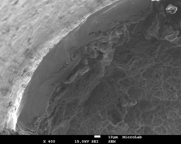 8 mm and the amplification of the fracture surface whre a characteristic ductile facies can be observed with dimples developed during the failure process.