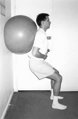 GF Stefanick Figure 5 Wall squats using the Swiss gym ball. Patient will lower the buttock toward the floor and raise back up working in a functional range of zero to 50 degrees of knee flexion.