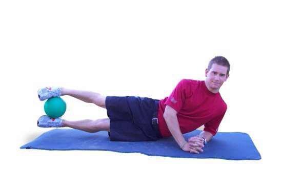 E2 MB Side Raises - Lie on your side with your elbows beneath your shoulders and your legs extended out. Place a medicine ball between your legs.