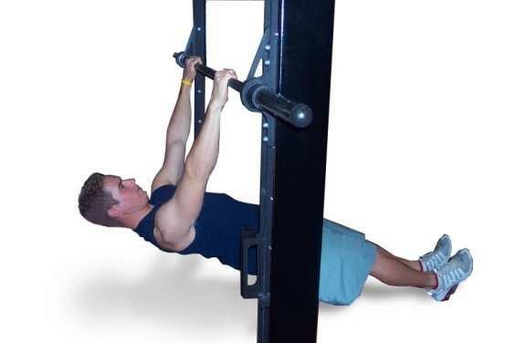 C2 Reverse Pull Ups - Lie underneath a squat rack or Smith machine. Grab bar with overhand grip just slightly beyond shoulder width. Place feet close together with heels against floor.