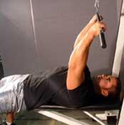 Lying Close-Grip Bar Curl On High Pulley Main Muscle Worked: Biceps Equipment: Cable Tips: Place a flat bench in front of a high pulley or lat pulldown machine.